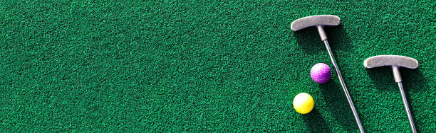 istock Mini golf clubs and balls on putting green 1445593236