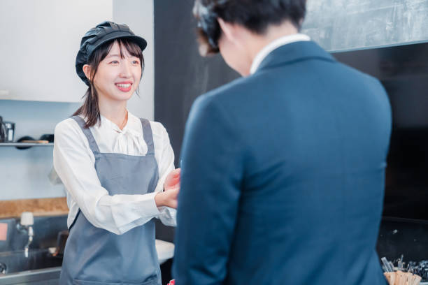 istock Male customer making a credit card payment at a cafe 1445599860