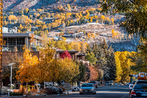 Aspen, USA - October 11, 2019: Main street road in ski resort town city of Aspen, Colorado in fall autumn or winter with snow by luxury houses homes