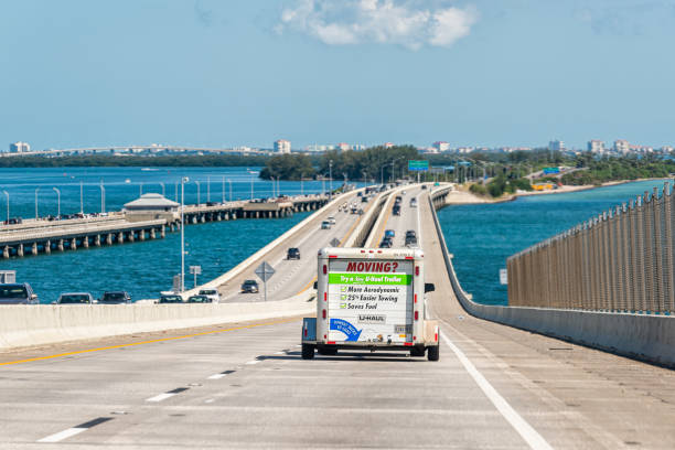 Bridge over Tampa Bay, Florida with Uhaul u-haul trailer attached to car vehicle for moving relocation road freeway stock photo