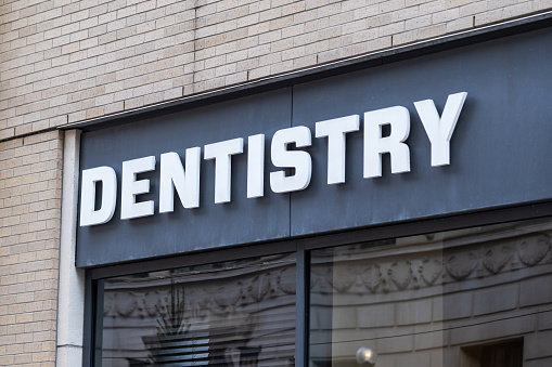 Dentistry street sign on the building in town