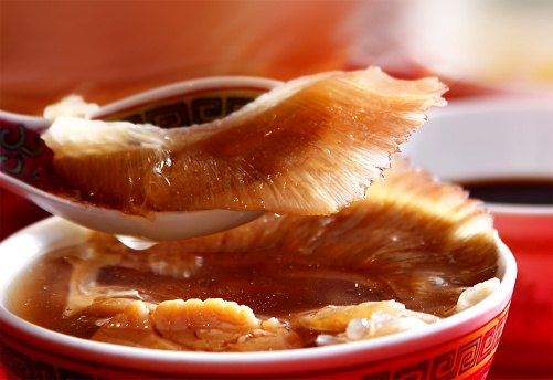 food chinese shark fin use aspoon to scoop up from the roud cup