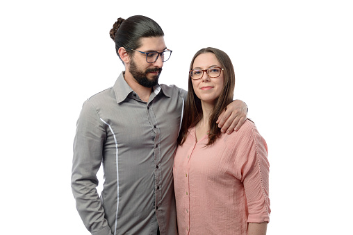 Latin man next to beautiful Caucasian woman in photo studio with white background