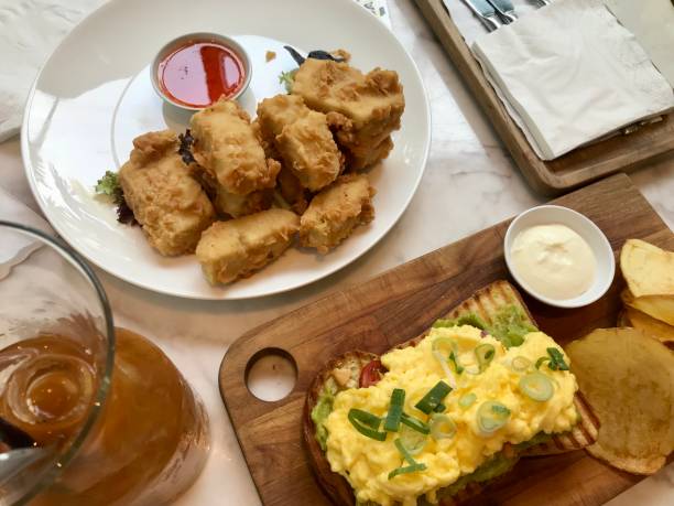 istock Avocado Toasted Bread With Scrambled Eggs Served With Potato Chips and Crispy Fried Tofu 1445615350