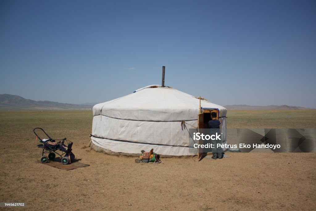 A picture of the nomadic family in the serene Tuv steppe, Mongolia. A picture of the nomadic family in the serene Tuv steppe, Mongolia. The family lives alone in the vast steppe. They moves out to other steppes each year. 6-7 Years Stock Photo