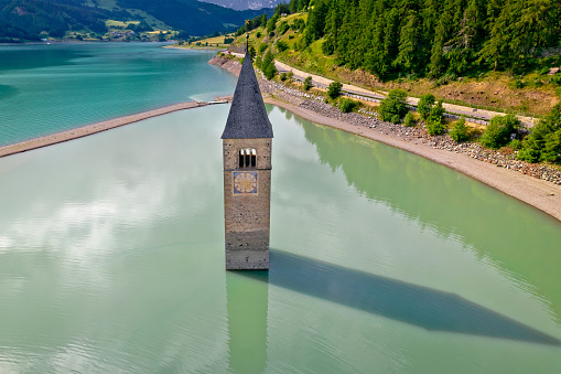 Submerged bell Tower of Curon Venosta or Graun im Vinschgau on Lake Reschen aerial view, South Tyrol region Italy