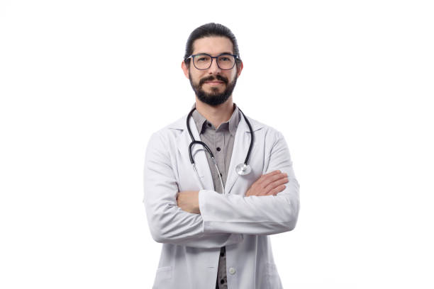 Young latin doctor with beard wearing white coat photographed in studio against white background stock photo