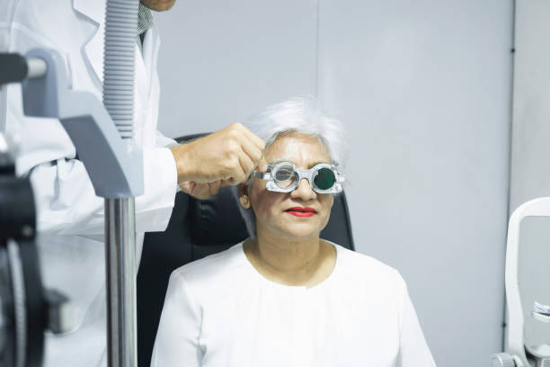 istock Woman examining eyesight in optical clinic. 1445633979