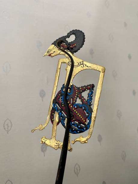 istock wayang arjuna character with flower background 1445634632