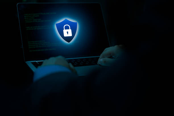 istock cybersecurity danger online data fraud or identity theft lock to protect from cyber scam, Laptop computer with hacker virus code in screen. 1445634674