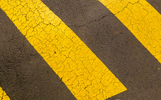 Asphalt texture with a Cracked and Yellow Line