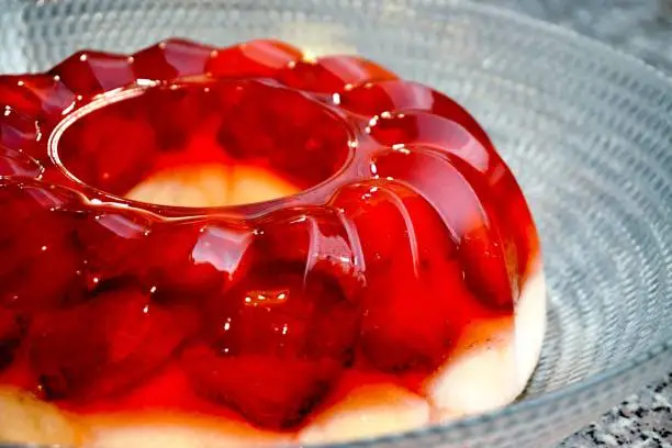 A closeup of strawberry cake with gelatin in glass dish