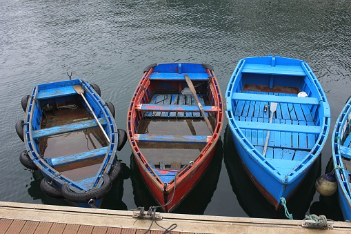 small boats in a sad, rainy, summer sunday