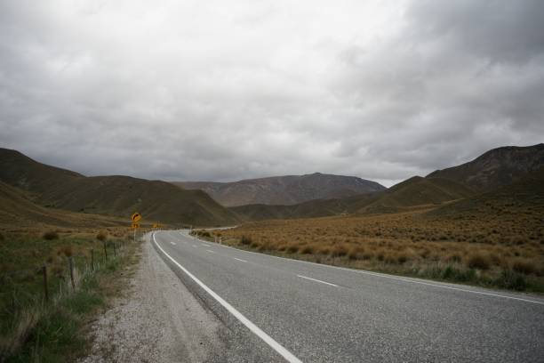 istock Highway going through the dry hilly field on a cloudy day 1445640584