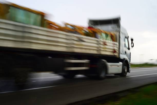 istock Cargo industrial truck in motion fast on a highway 1445640979