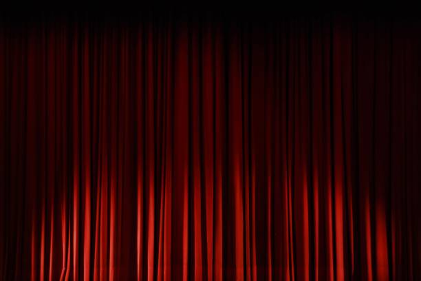 istock Closeup shot of closed red curtains on a stage 1445640982