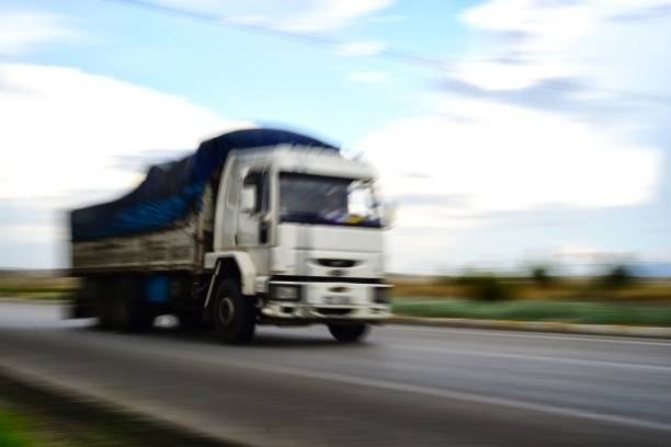 istock Large truck passing by with a panning speed effect on the road 1445641050