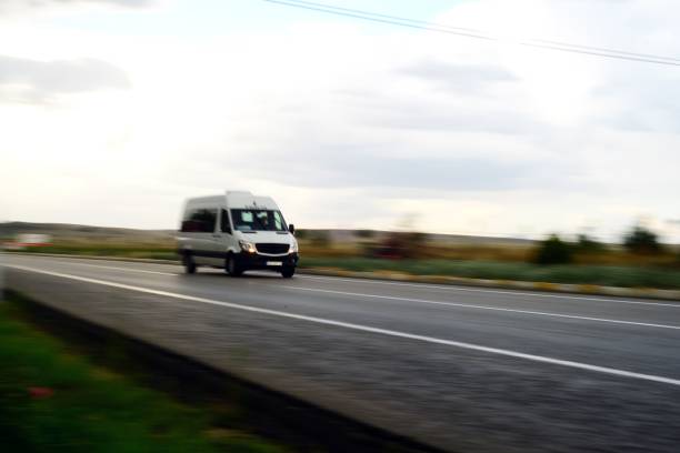 Lisbon, Portugal, May 8, 2025, White van towing a small red food trailer on a sunny day