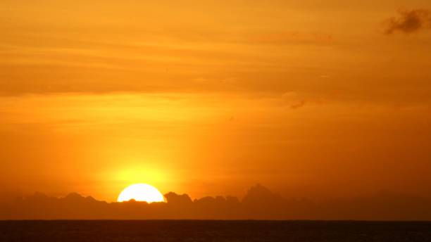 istock Bright orange sunset sky over a seashore 1445641823