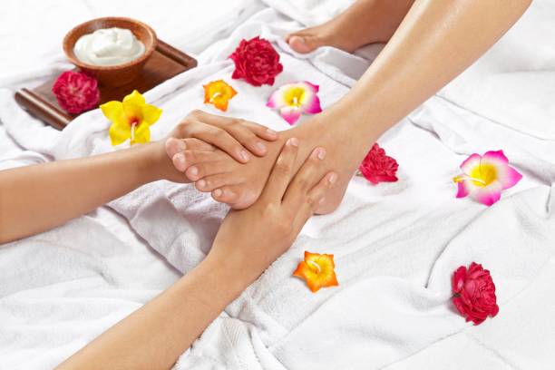 istock Specialist giving a foot massage treatment to a client 1445642007