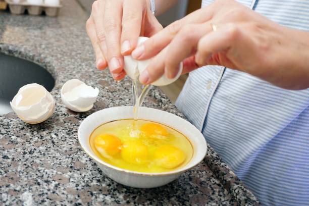 istock White eggs and woman hand preparation in kitchen 1445642153