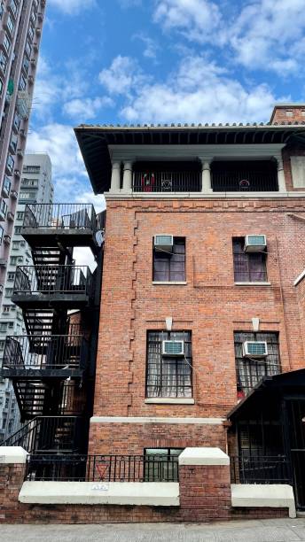 istock Vertical low-angle closeup of a high stone building with an emergency staircase 1445642171