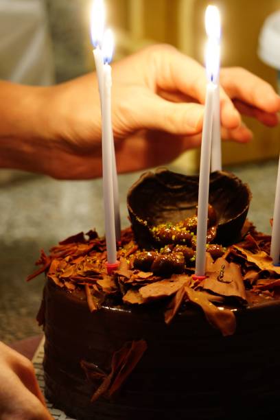 istock Vertical shot of a birthday celebration chocolate cake with candles 1445642486