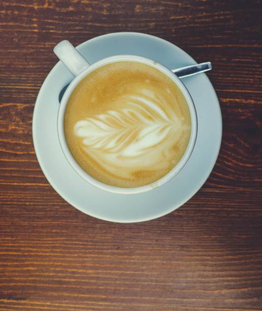 Top view of a cup of Cappuccino coffee with latte art topping
