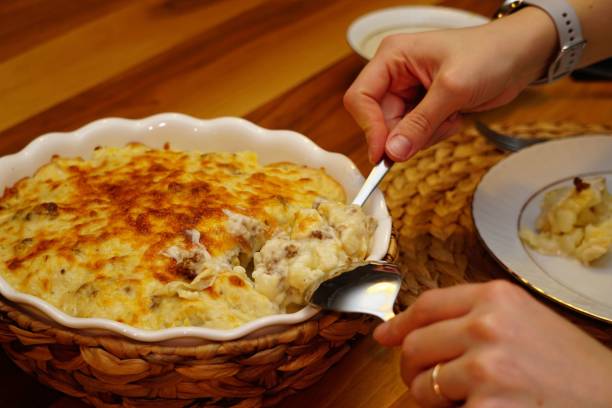 istock High-angle view of hands taking the meal with melted cheese on top from a bowl 1445643406