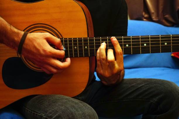 istock Closeup of the hands playing the guitar. 1445643503
