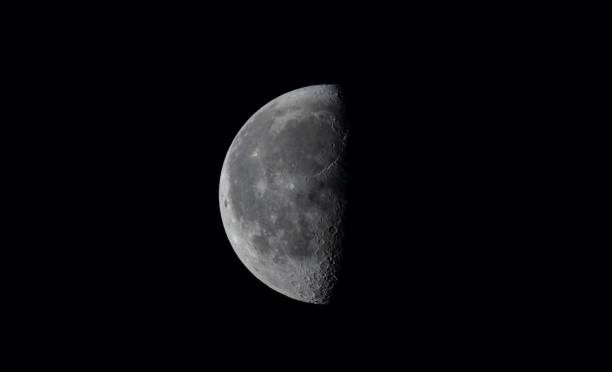 Closeup of a half moon shining in a dark sky