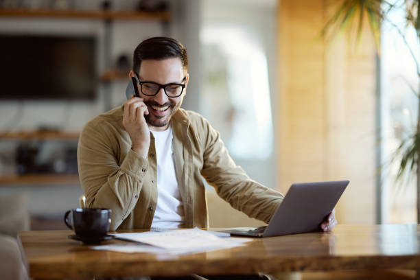 istock Happy  businessman having a phone call while working at home office. 1445647337