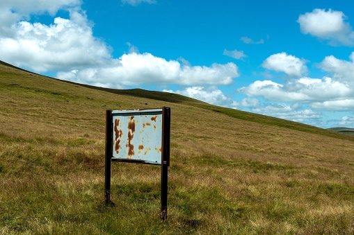 An old panel on a slope of a bare hill in France
