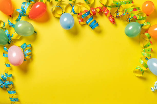 istock Birthday background top view Party decorations on yellow background with copy space 1445649227