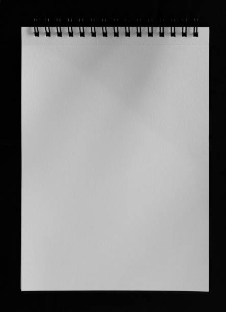 istock Closeup of a white paper isolated on a black background 1445651486