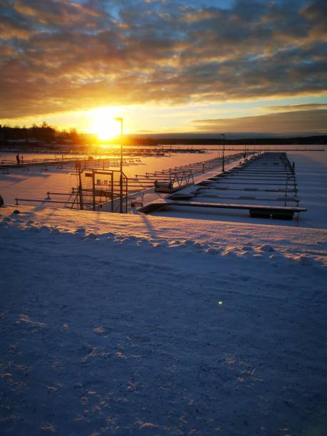 istock Vertical shot of a snow-covered  harbor during a scenic sunset 1445652500