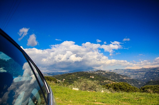 The car glass reflecting the landscape of Kadisha Valley with blue sky, Bsharri, Northern Lebanon