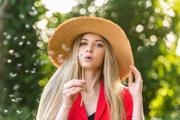 Portrait of a young woman in nature. About 20 years old blonde with blue eyes.