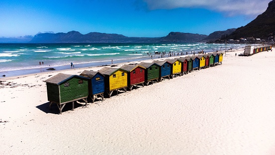 Brighton beach Victorian bathing boxes. Brightly painted colourful beach huts line the sand in Melbourne, Australia. They are highly desirable and extremely expensive real estate.