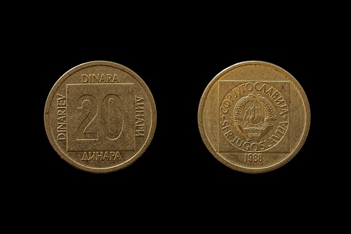 Two Republic of Yugoslavia Dinar coins isolated on a dark background