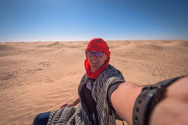 istock Caucasian man taking a selfie on a dessert 1445655692
