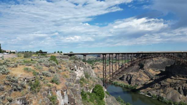 istock Beautiful landscape with a bridge over a river flowing along the cliffs under a cloudy sky 1445656878