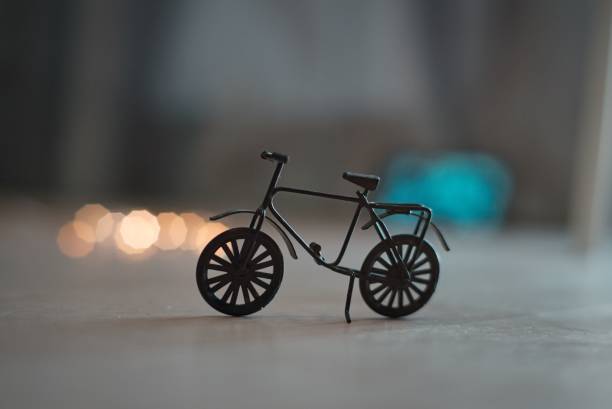 istock Closeup shot of a small bicycle figurine on a table 1445658704