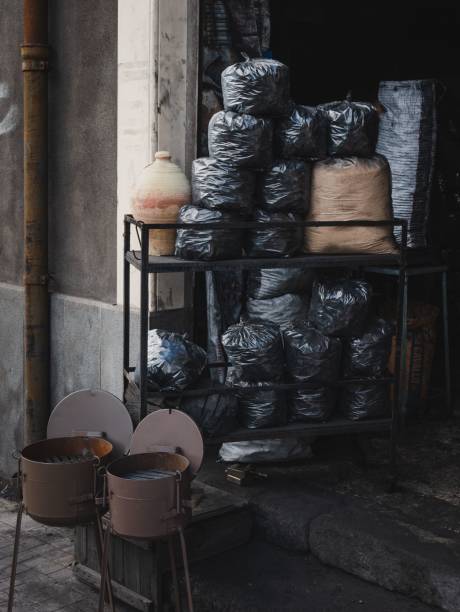 Ancient traditional coal shop in the streets of Catania in Sicily, Italy with barbecue and sacks. Ancient traditional coal shop in the streets of Catania in Sicily, Italy with barbecue and sacks of coal. hard bituminous coal stock pictures, royalty-free photos & images