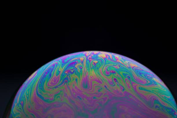 istock Half a soap bubble. Close-up. Black background. Bright colors. Side view. Imitation of an unknown pl 1445661094