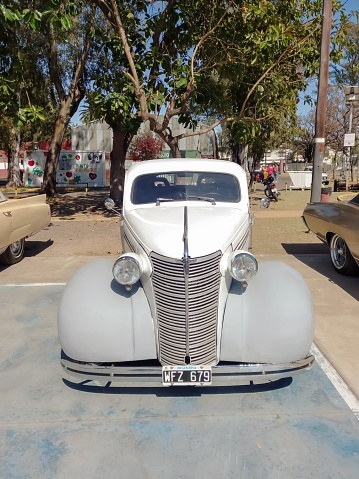 Lanus, Argentina – September 25, 2022: Lanus, Argentina - Sept 24, 2022: old 1938 Chevrolet Chevy Master coupe by GM in a park. Sunny day. AAA 2022 classic car show. Front view. High angle.