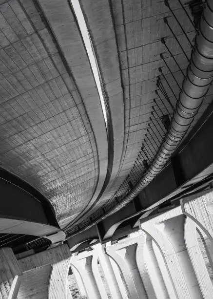 Photo of Vertical grayscale shot of the underside of the A45 bridge in Wetzlar, Germany