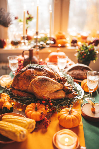 istock Thanksgiving holiday dinner table setting with fall decoration and pumpkins 1445666996