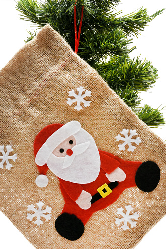Burlap Santa Claus bag with Christmas ornaments hanging on the Christmas tree