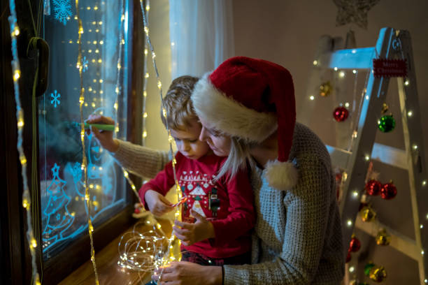 istock Young mother drawing with her boy on the window 1445672409